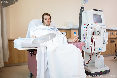 Image of Patient Listening To Music While Receiving Renal Dialysis