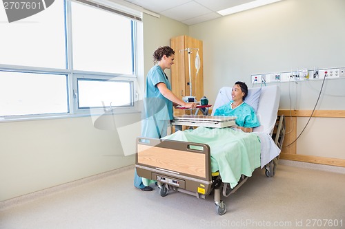 Image of Nurse Bringing Breakfast For Male Patient In Hospital