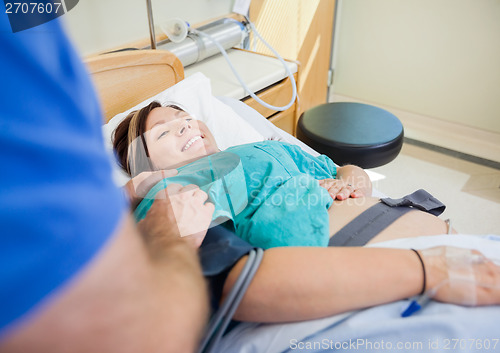 Image of Happy Pregnant Woman Lying In Hospital Bed