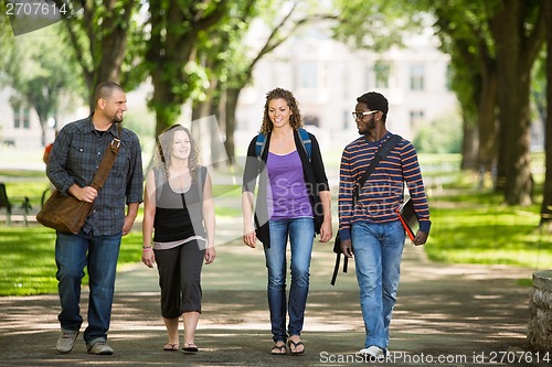 Image of Friends Walking On Campus Road