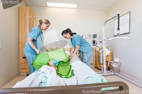 Image of Nurses Preparing Patient Before Transferring Him On Hydraulic Li