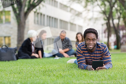Image of Student With Digital Tablet On Grass At Campus Park