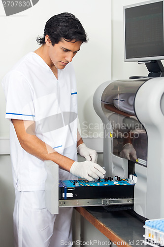 Image of Researcher Loading Solutions Into Analyzer