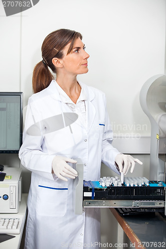 Image of Researcher Loading Samples In Coagulation Analyzer