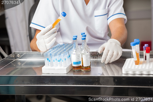 Image of Researcher Analyzing Sample In Test Tube