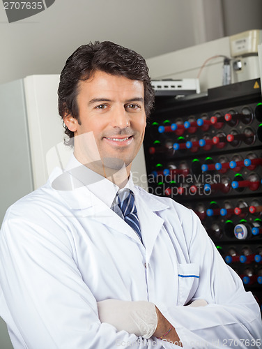 Image of Microbiologist Standing By Blood Culture Instrument