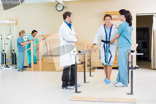 Image of Physical Therapists Assisting Female Patient In Walking