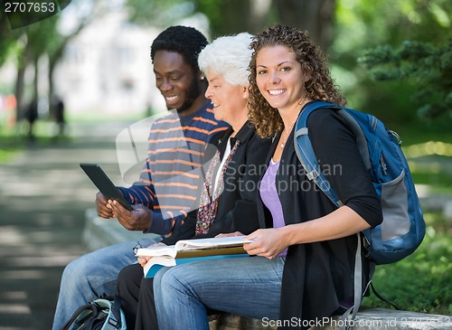 Image of University Students Sitting On Parapet At Campus