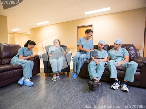 Image of Medical Team Using Technologies In Hospital's Waiting Room