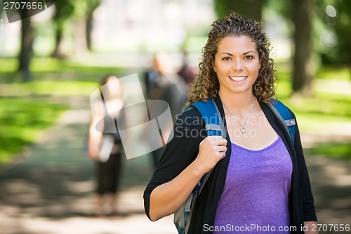 Image of Happy Female Student Standing At Campus