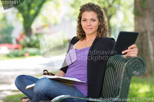 Image of Beautiful Student Sitting On Bench At Campus