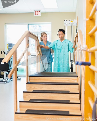 Image of Male Patient Being Assisted By Physical Therapist