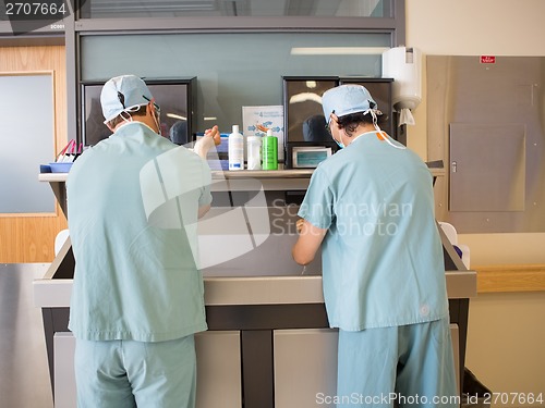 Image of Surgeons Scrubbing Hands