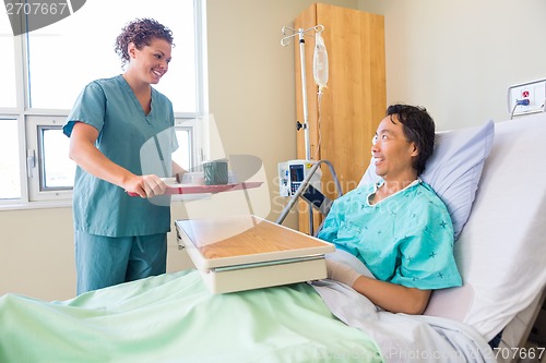 Image of Friendly Nurse Bringing Breakfast For Patient In Hospital