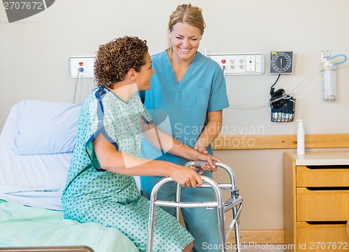 Image of Nurse Assisting Patient Using Walking Frame In Hospital