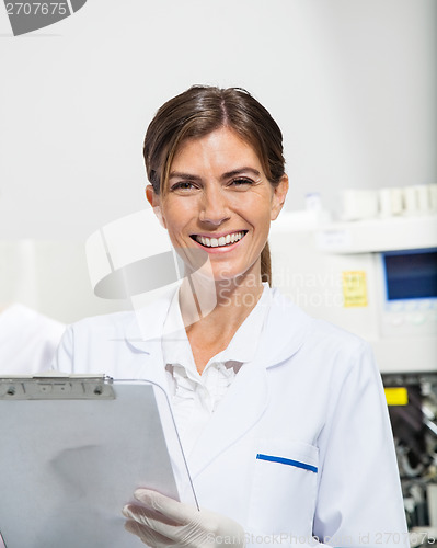 Image of Scientist Holding Clipboard In Laboratory