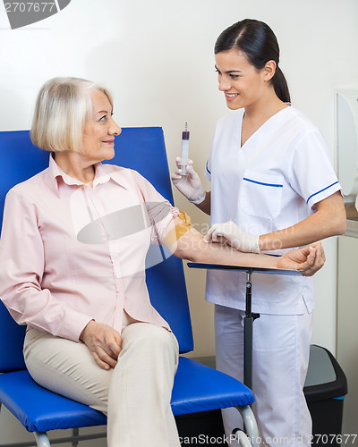 Image of Businesswoman Undergoing Blood Test