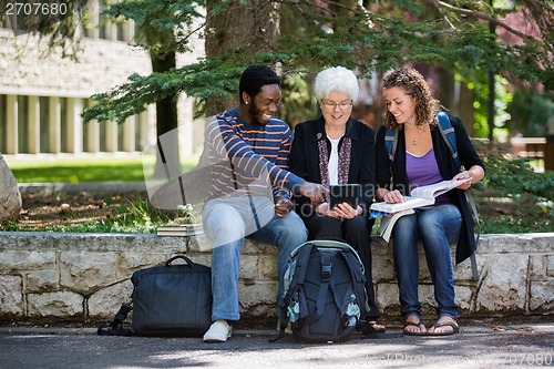Image of Happy University Students Using Digital Tablet On Campus