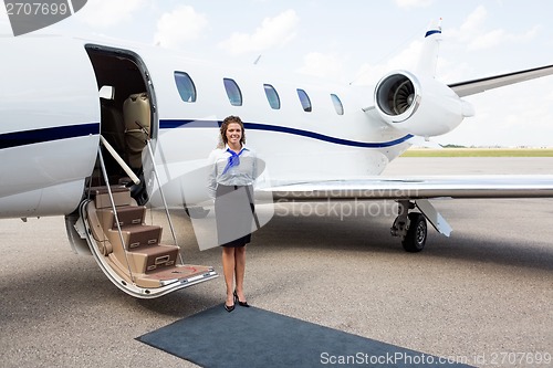 Image of Airhostess Standing By Private Jet