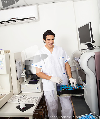 Image of Scientist Loading Analyzer With Samples