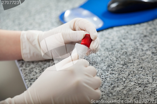 Image of Technician Labeling Test Tube In Lab