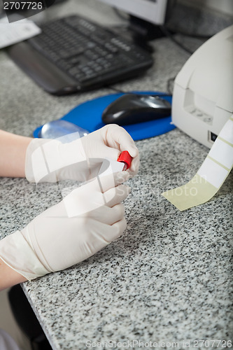 Image of Technician Labeling Test Tube In Lab