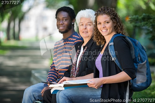 Image of Confident University Students Sitting On Campus