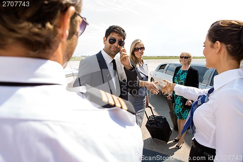 Image of Corporate People Greeting Pilot And Airhostess At Airport