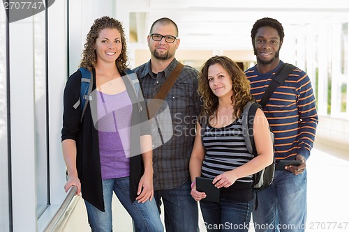 Image of Confident University Students Standing At Corridor