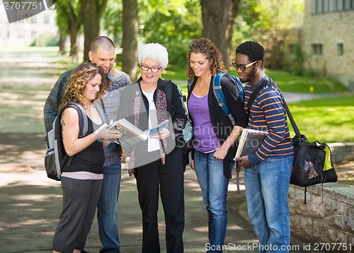 Image of Students Discussing Notes On Campus