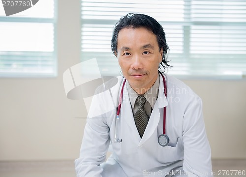 Image of Confident Doctor Sitting In Hospital Room