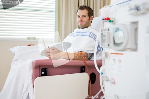 Image of Patient Holding Mobilephone at Renal Dialysis Center