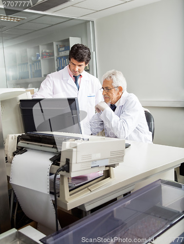 Image of Researcher Discussing Over Computer