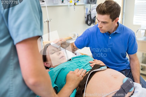 Image of Man Cooling Forehead With Cloth