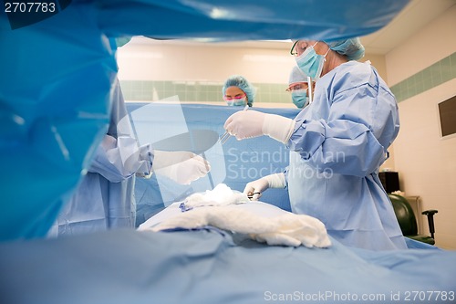 Image of Team Of Surgeons Operating