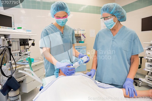 Image of Nurses Putting Oxygen Mask On Patient