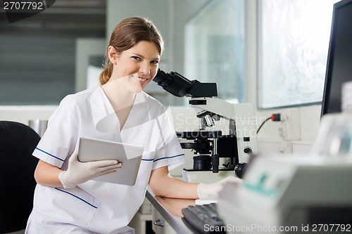 Image of Female Scientist Holding Digital Tablet In Lab