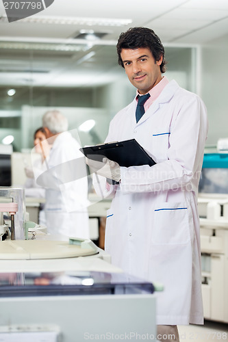 Image of Scientist With Clipboard In Laboratory