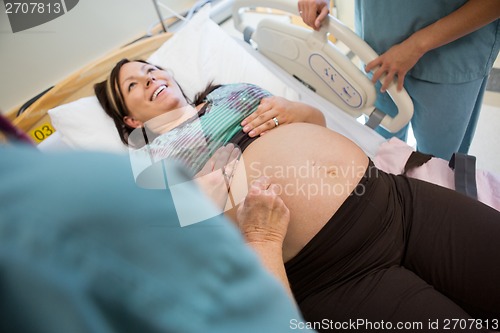 Image of Pregnant Woman Being Examined By Nurses