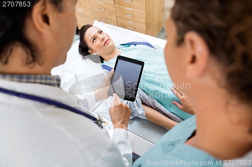 Image of Medical Team With Patient In Hospital Room