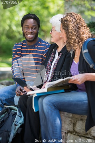 Image of University Students Sitting with Professor