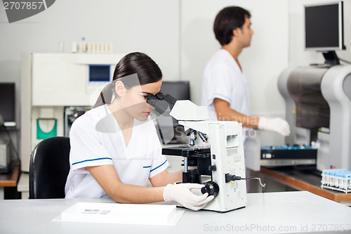 Image of Female Scientist Using Microscope In Lab