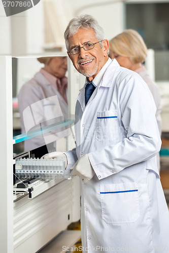 Image of Researcher Loading Samples In Analyzer