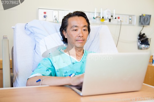 Image of Patient Using Laptop On Hospital Bed