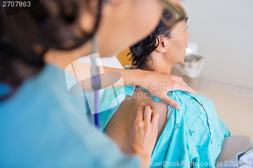 Image of Female Nurse Checking Patient's Back With Stethoscope