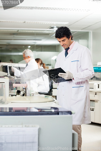 Image of Researcher Reading Clipboard