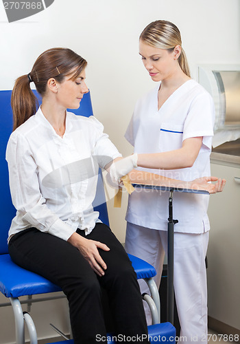 Image of Nurse Preparing Businesswoman For Blood Test