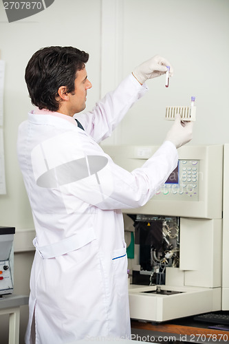 Image of Scientist Loading Analyzer With Samples