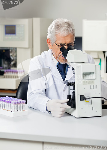 Image of Male Scientist Using Microscope In Lab