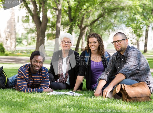 Image of Students Sitting On Grass At Campus Park